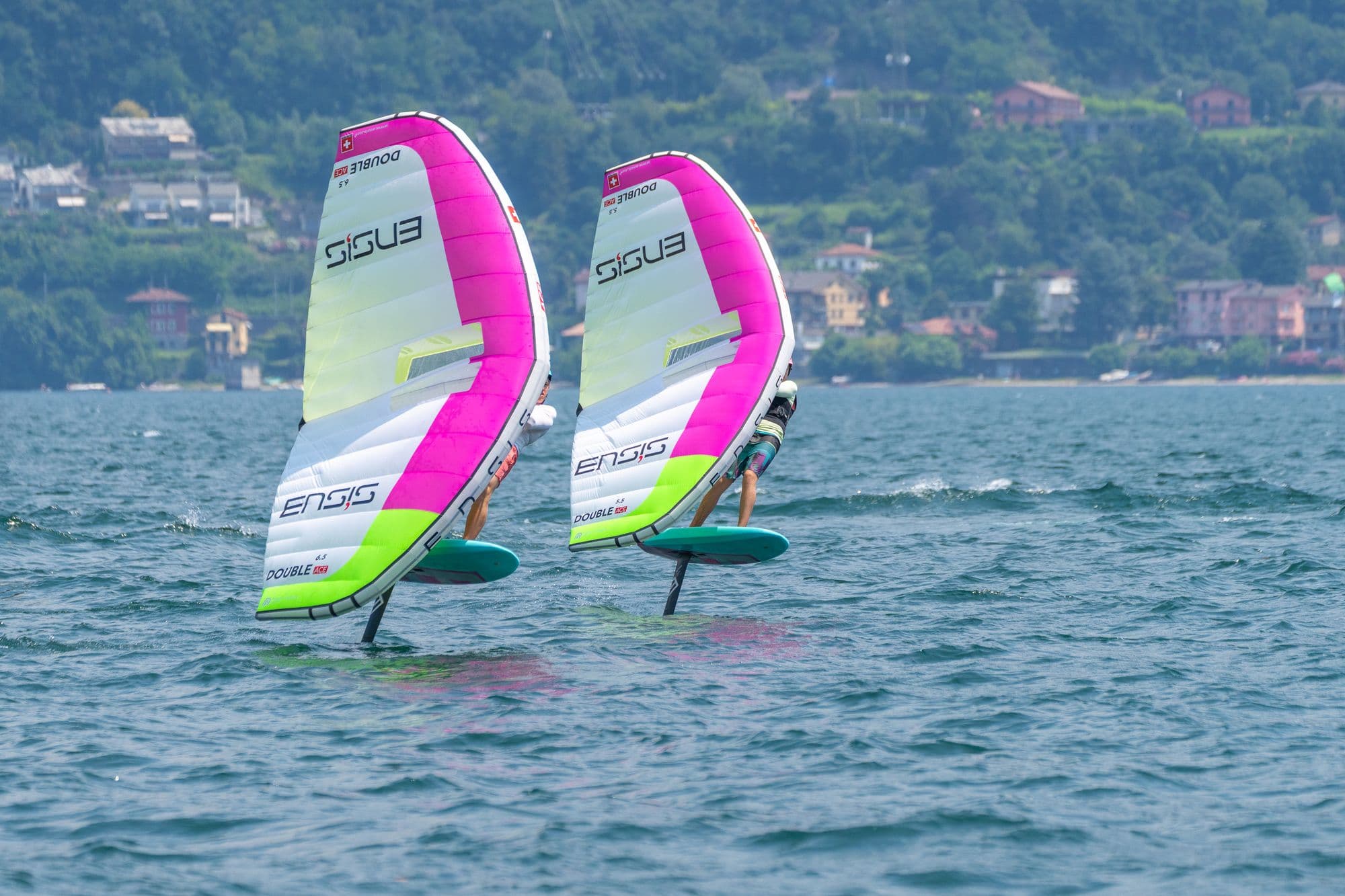 Zwei Wingfoiler nebeneinander auf offenem Wasser