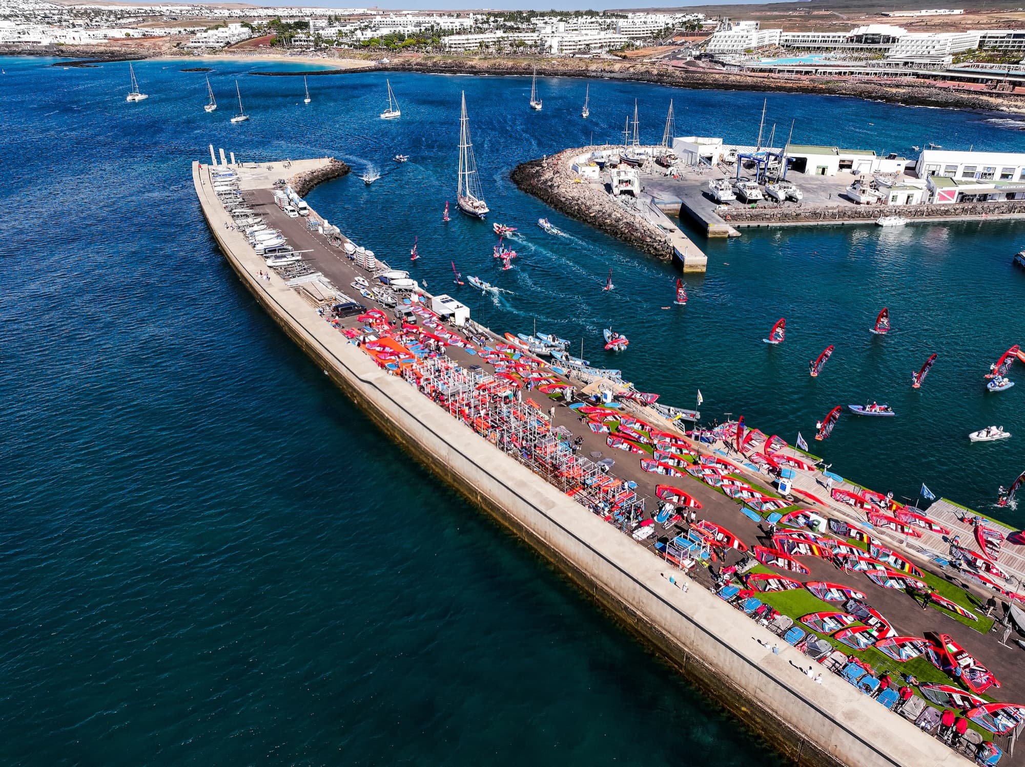 Luftaufnahme der ganzen Marina: die lange Mole mit dem Boat Park, die Hafeneinfahrt und die Hotels am Strand